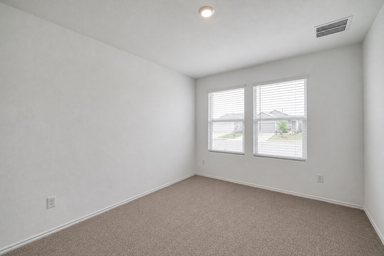 23412 Tiny Moons Way Elgin, TX 78621 - Photo 17 of 38 Carpeted room with white walls, two windows, recessed lighting, and a ceiling vent