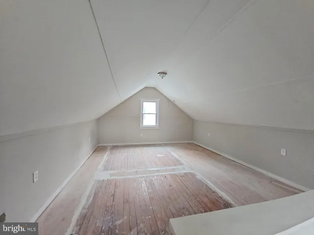 a view of wooden floor and window in a room