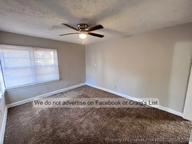 a view of a ceiling fan and hardwood floor