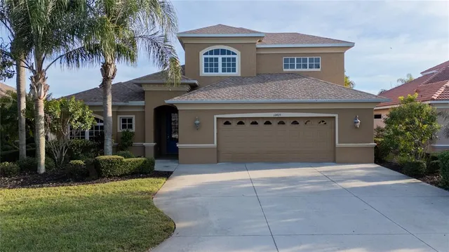 a front view of a house with a garden and garage