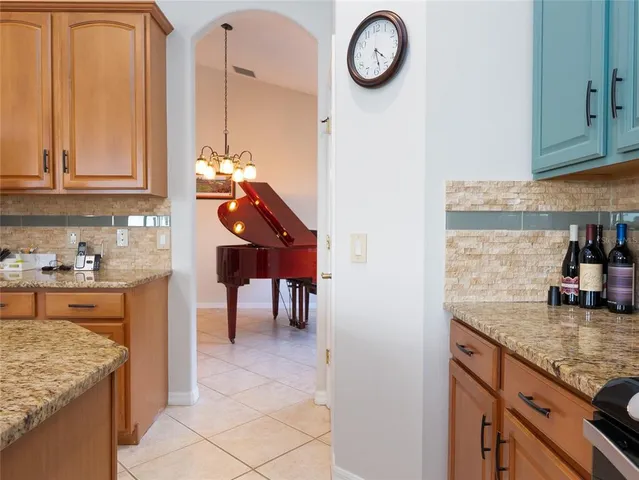 a kitchen with granite countertop a sink a stove and cabinets