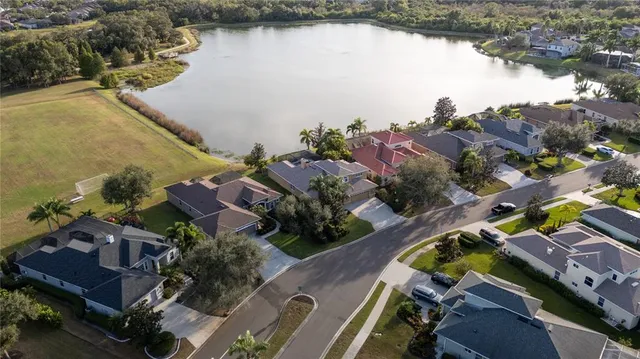 an aerial view of a house with outdoor space and lake view