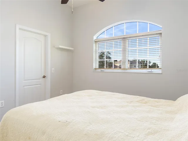 a bathroom with a granite countertop sink a toilet a mirror and shower