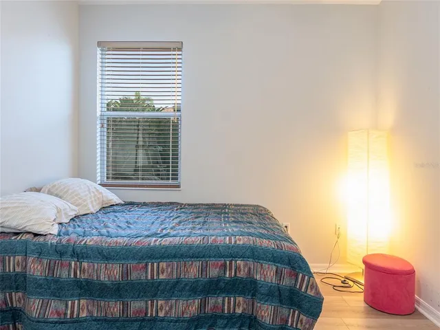 a bedroom with a bed and a window