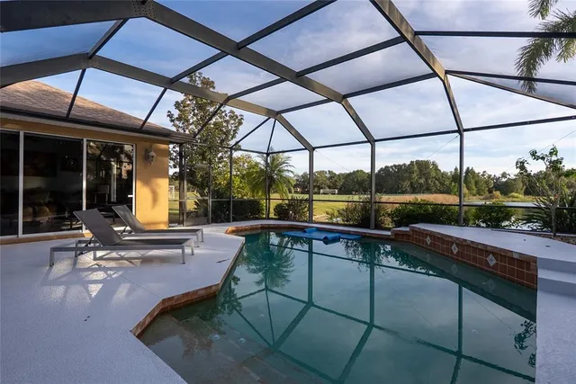 a aerial view of a house with a yard and lake view