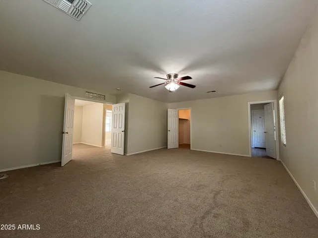 a view of a livingroom with a ceiling fan and window