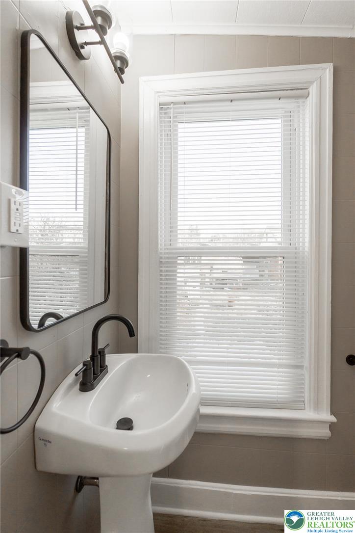 2213 Village Road Orefield, PA 18069 - Photo 15 of 41 a bathroom with a sink a toilet and a window