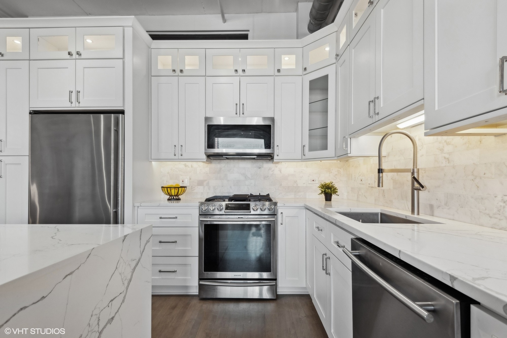1301 West Madison Street, Unit 501 Chicago, IL 60607 - Photo 11 of 30 a kitchen with granite countertop a sink stove and refrigerator