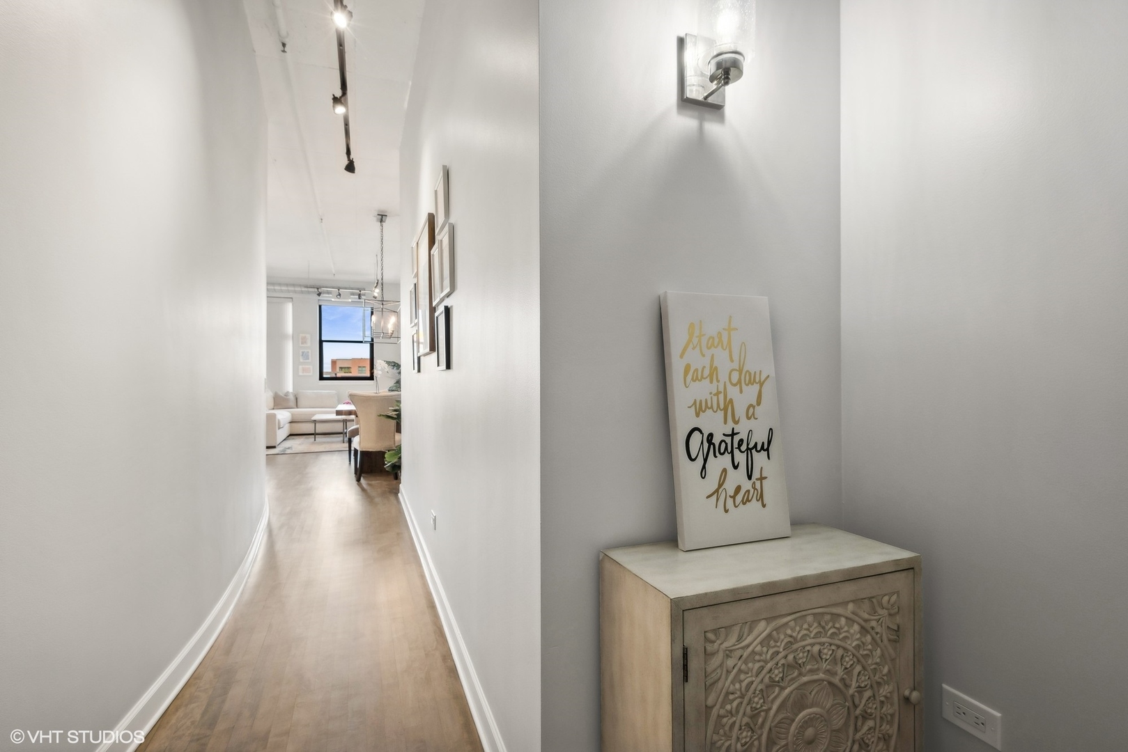 1301 West Madison Street, Unit 501 Chicago, IL 60607 - Photo 21 of 30 a view of a hallway with wooden floor and a bathroom