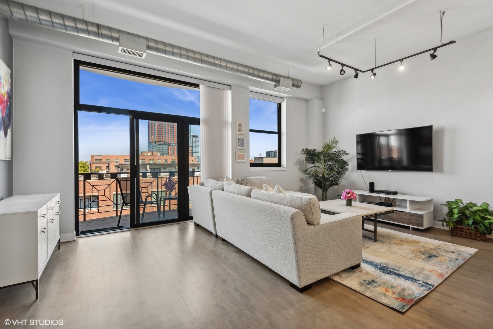 1301 West Madison Street, Unit 501 Chicago, IL 60607 - Photo 5 of 30 a living room with furniture and a flat screen tv