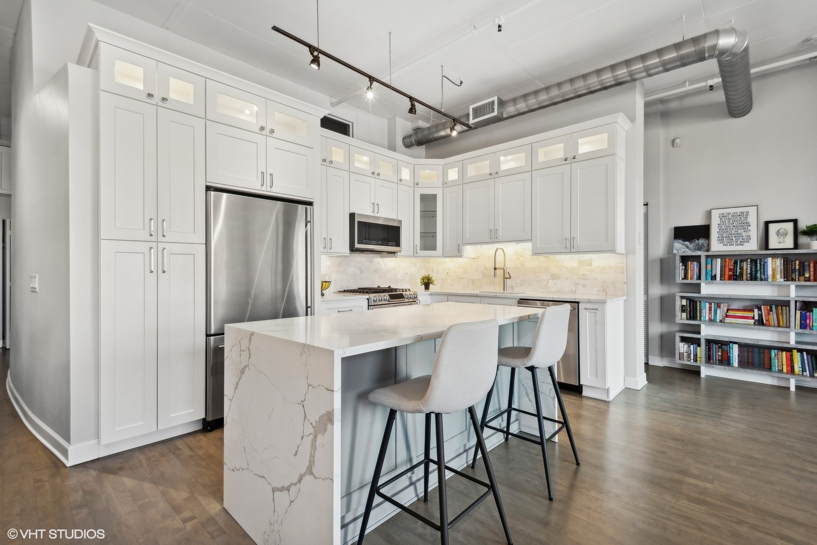 1301 West Madison Street, Unit 501 Chicago, IL 60607 - Photo 8 of 30 a kitchen with stainless steel appliances a dining table chairs refrigerator and cabinets