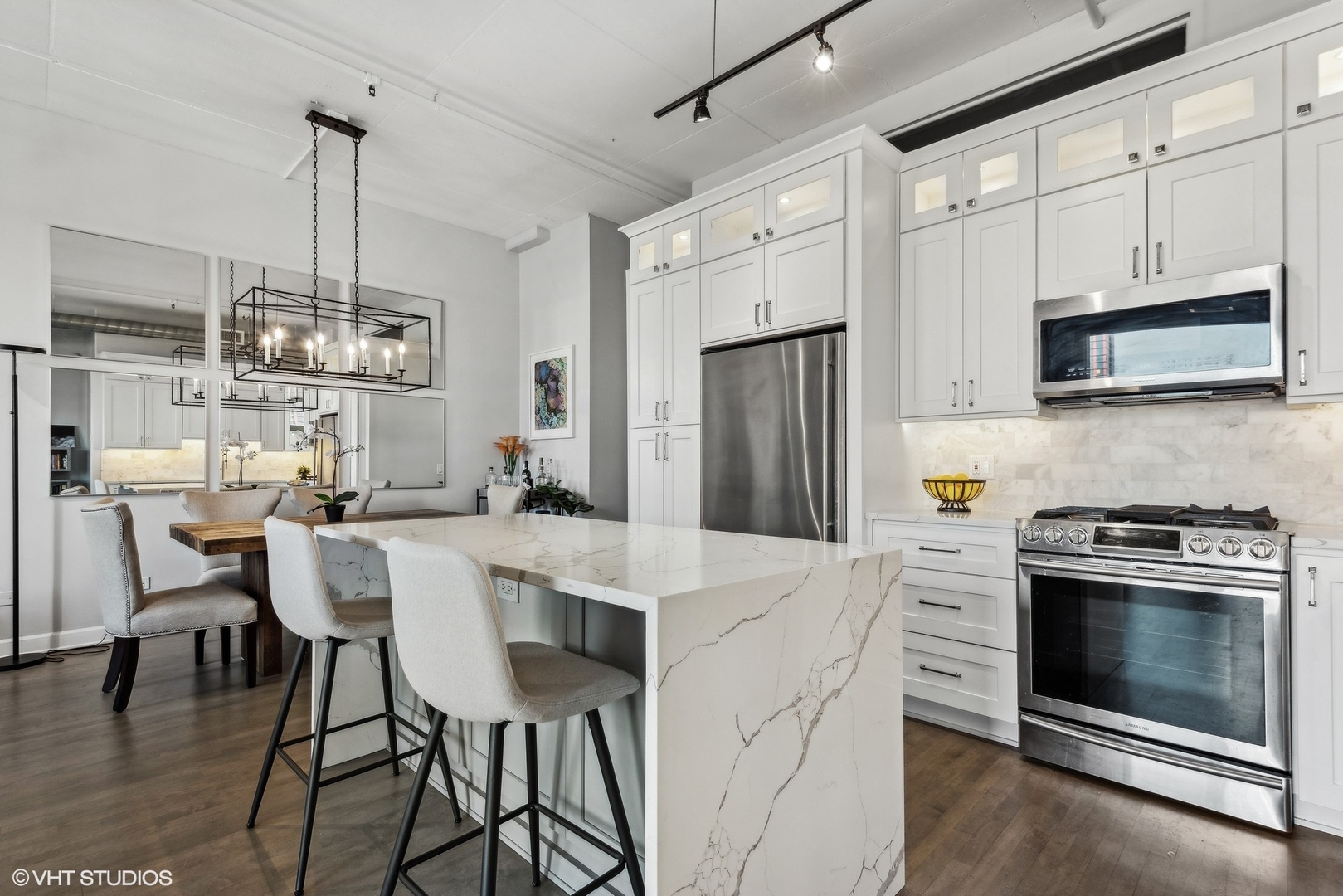 1301 West Madison Street, Unit 501 Chicago, IL 60607 - Photo 10 of 30 a kitchen with stainless steel appliances a stove a refrigerator sink and cabinets