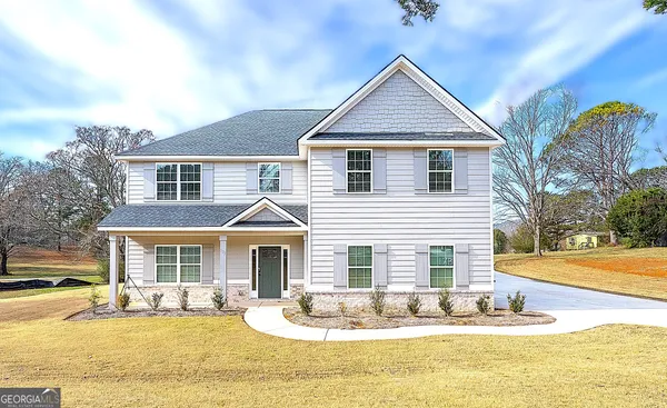 a front view of a house with a yard