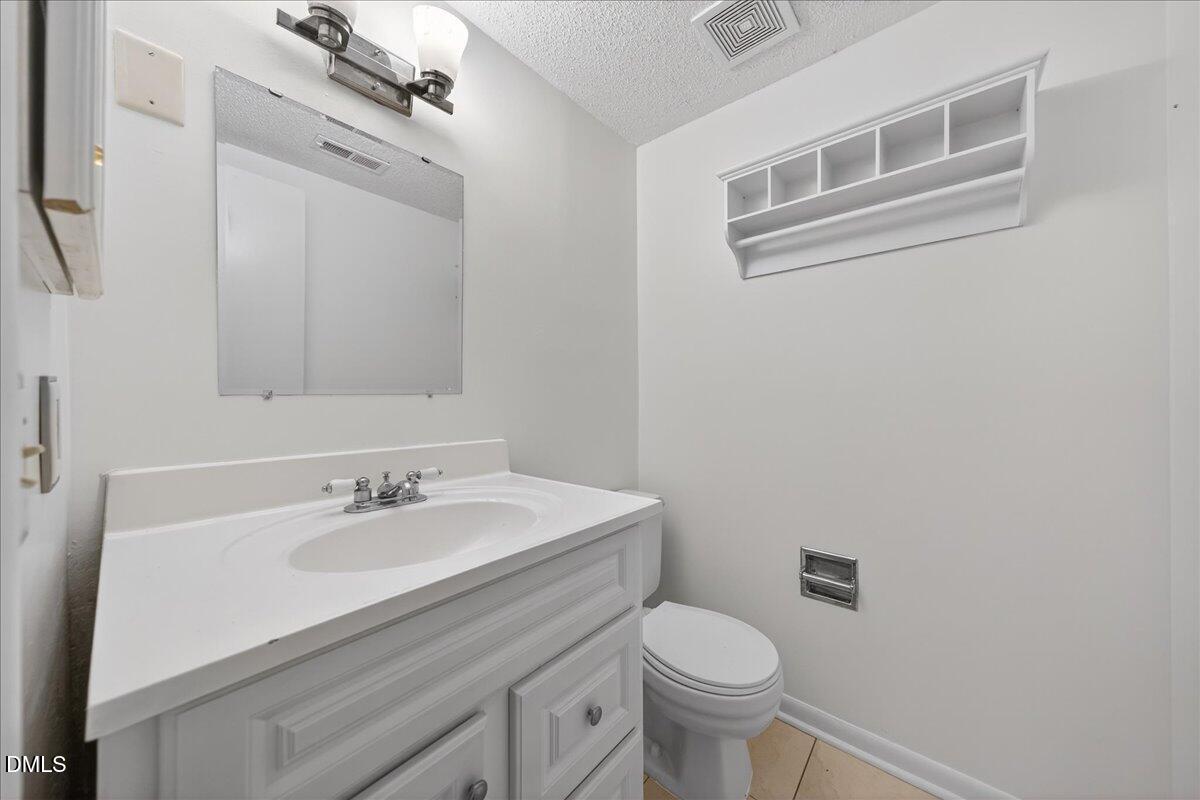 3088 Colony Road, Unit 3088D Durham, NC 27705 - Photo 18 of 25 a bathroom with a sink toilet and mirror