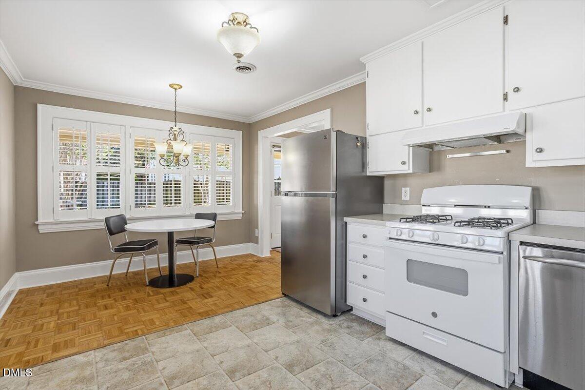 2609 Davis Street Raleigh, NC 27608 - Photo 20 of 31 a kitchen with refrigerator cabinets and table