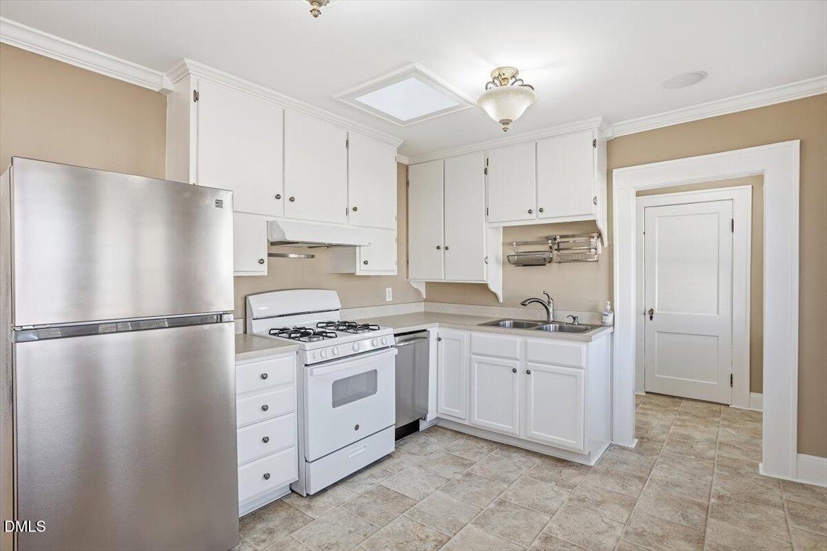 2609 Davis Street Raleigh, NC 27608 - Photo 22 of 31 a kitchen with cabinets a refrigerator and a stove