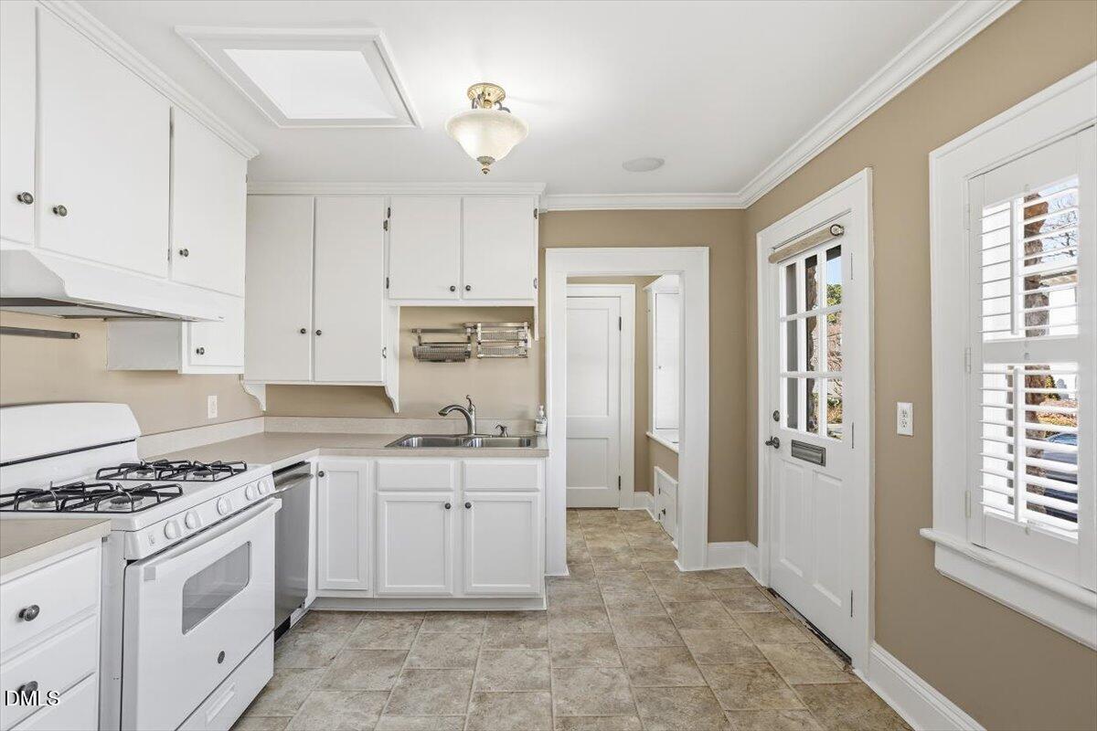 2609 Davis Street Raleigh, NC 27608 - Photo 23 of 31 a kitchen with stainless steel appliances granite countertop a stove a sink and a refrigerator