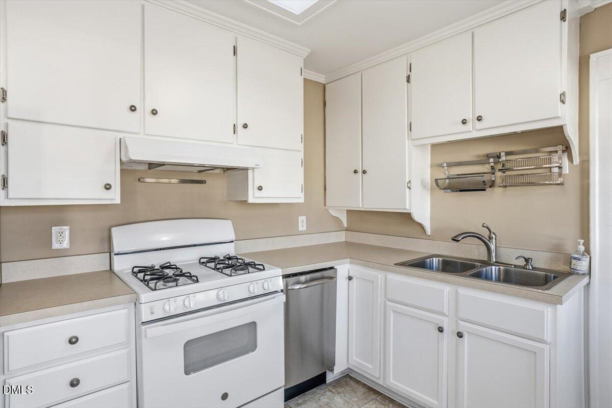 2609 Davis Street Raleigh, NC 27608 - Photo 24 of 31 a kitchen with cabinets appliances a sink and a stove