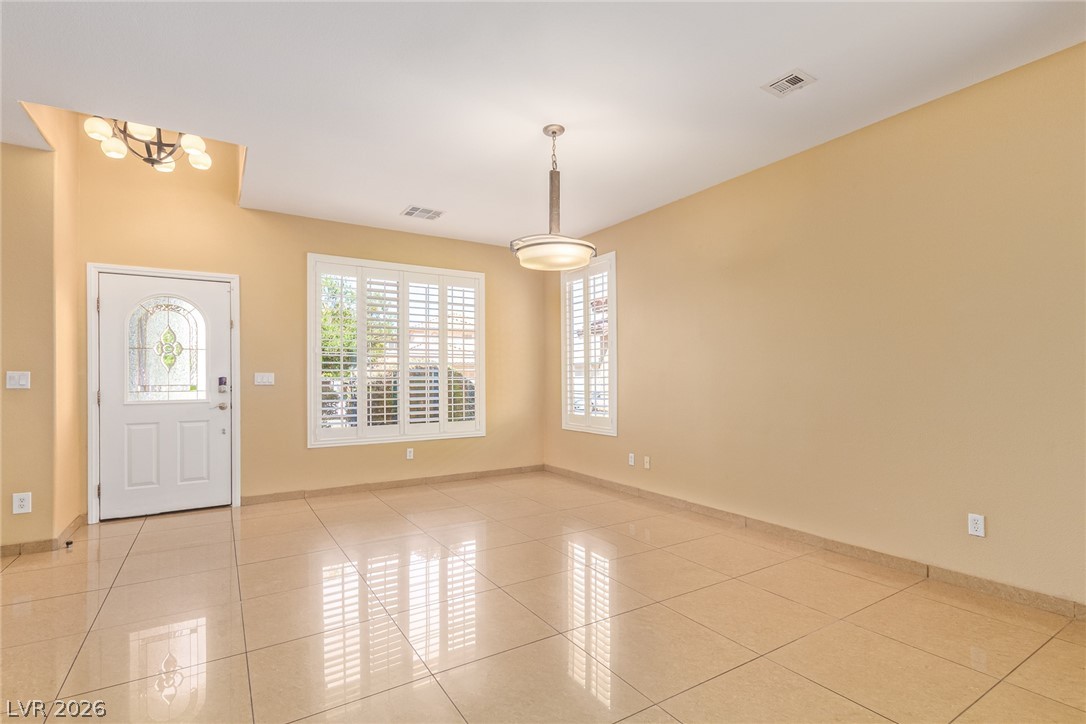 1477 Rancho Ridge Drive Henderson, NV 89012 - Photo 3 of 46 A well-lit entry with polished tile floors welcomes guests into a versatile open space.