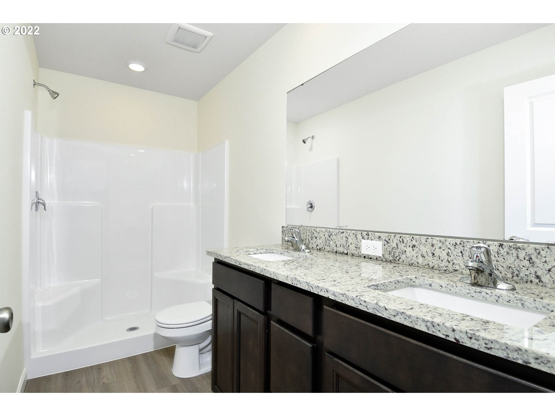 4149 Southwest Hartley Avenue Gresham, OR 97080 - Photo 6 of 8 a bathroom with a granite countertop sink a toilet and shower