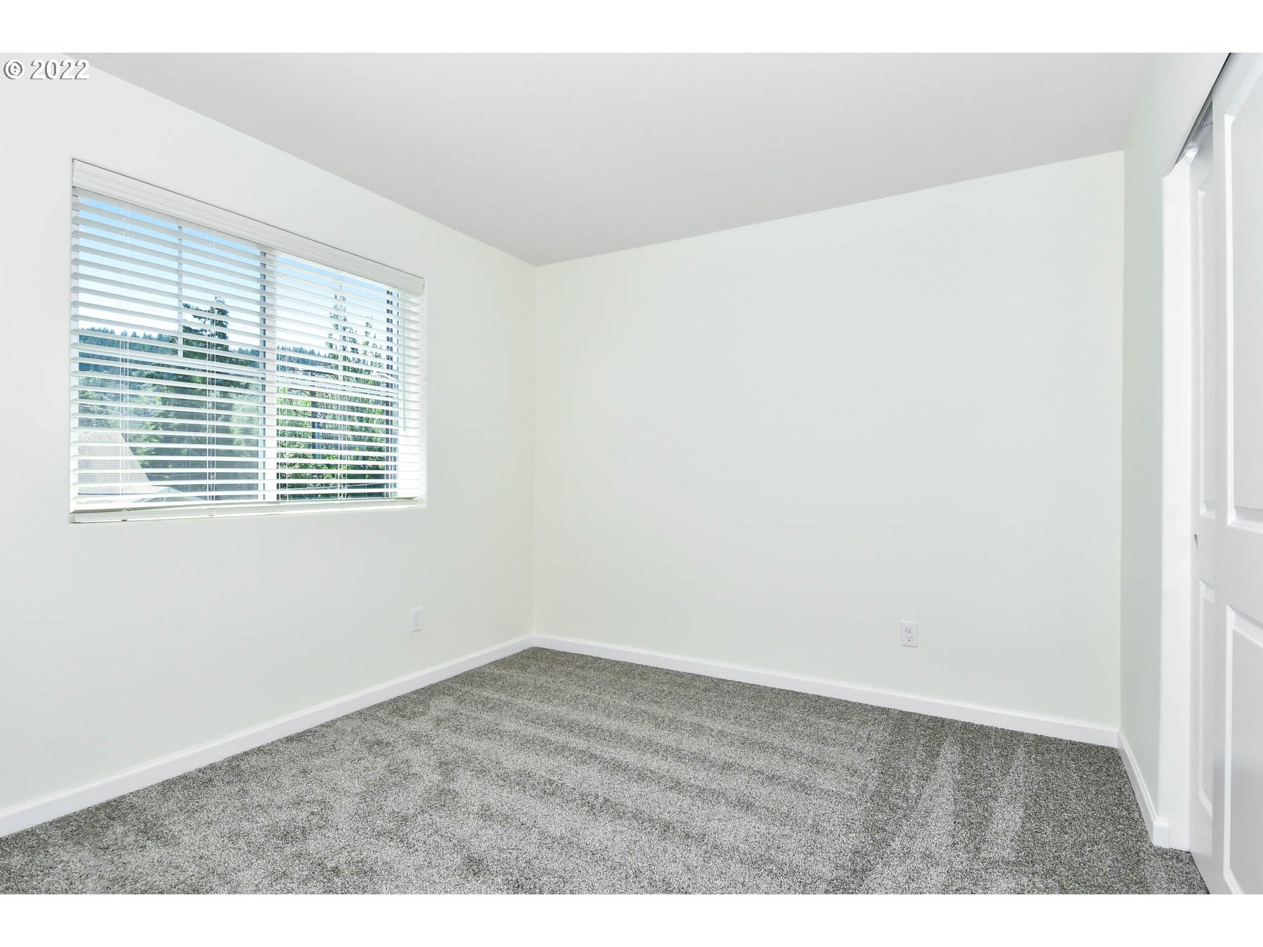 4149 Southwest Hartley Avenue Gresham, OR 97080 - Photo 7 of 8 a view of an empty room with wooden floor and a window