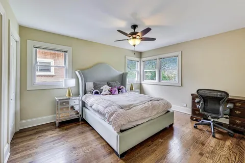 a bedroom with a bed a table and chair
