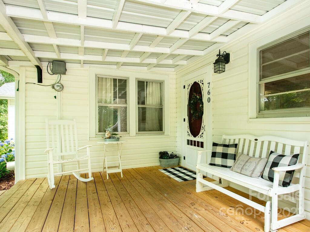 760 Kims Cove Road Canton, NC 28716 - Photo 5 of 37 a view of a balcony with chairs and wooden floor