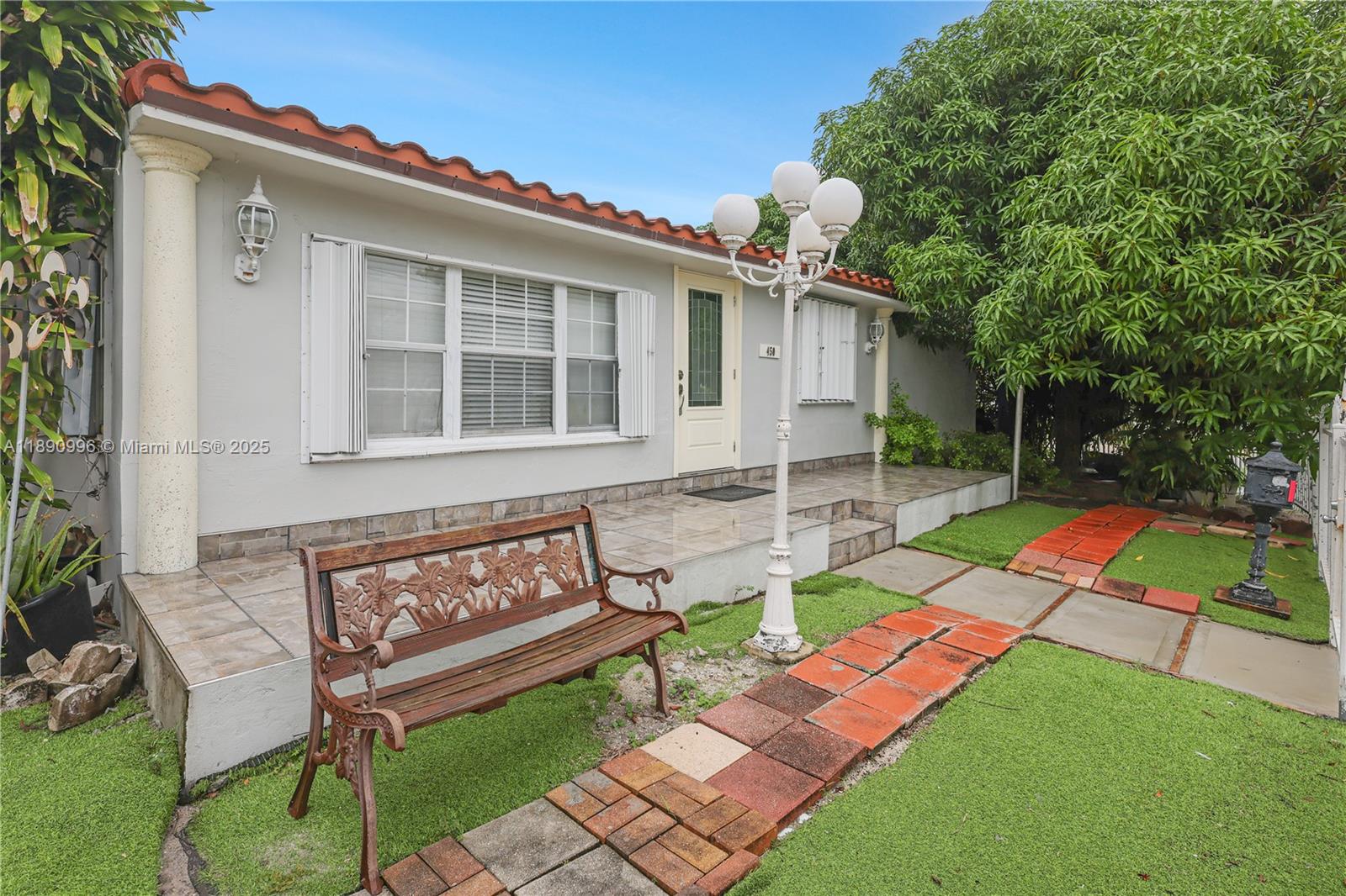 450 Northwest 40th Court Miami, FL 33126 - Photo 1 of 18 a view of a house with backyard sitting area and garden