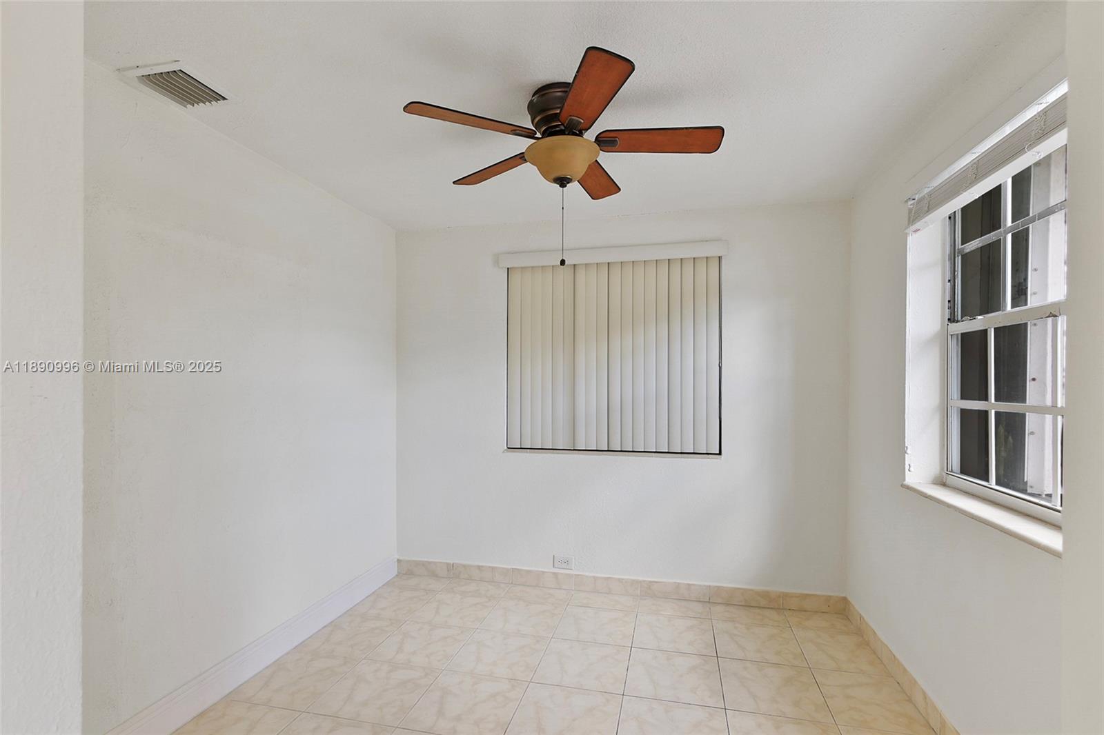 450 Northwest 40th Court Miami, FL 33126 - Photo 11 of 18 a view of empty room with window and ceiling fan