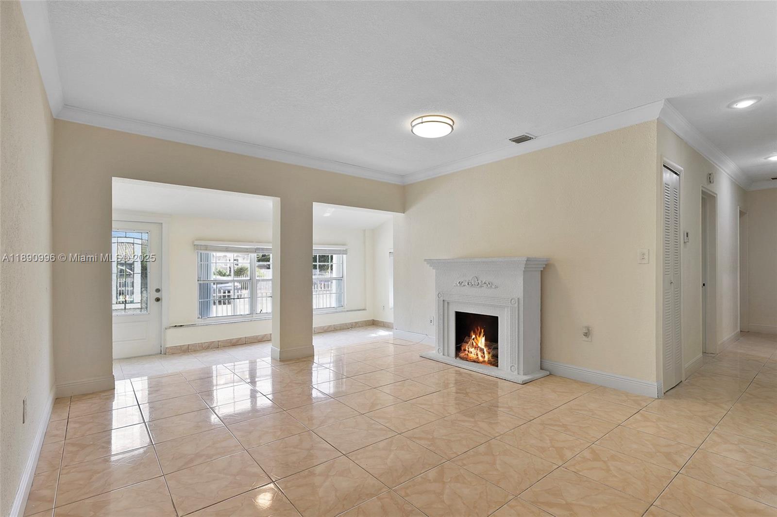 450 Northwest 40th Court Miami, FL 33126 - Photo 7 of 18 a view of an empty room with a fireplace and a window