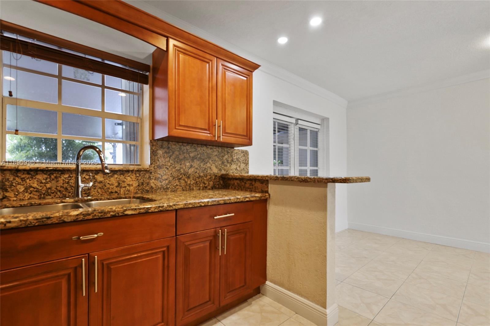 450 Northwest 40th Court Miami, FL 33126 - Photo 10 of 18 a kitchen with stainless steel appliances granite countertop a sink and cabinets
