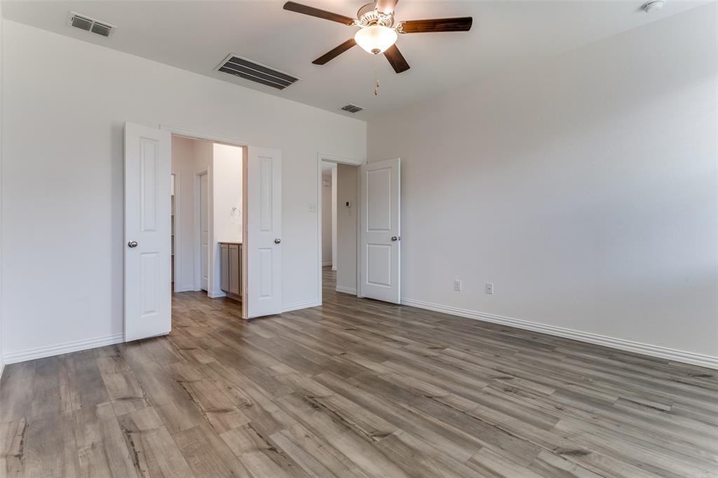 1207 Mesquite Lane Princeton, TX 75407 - Photo 18 of 25 a view of an empty room with wooden floor