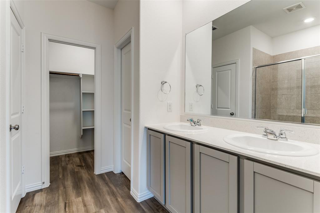 1207 Mesquite Lane Princeton, TX 75407 - Photo 21 of 25 a bathroom with a sink and a mirror