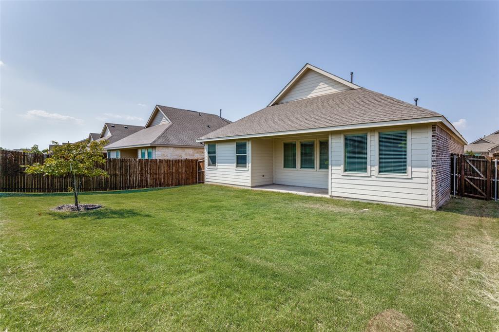 1207 Mesquite Lane Princeton, TX 75407 - Photo 24 of 25 a front view of a house with a garden
