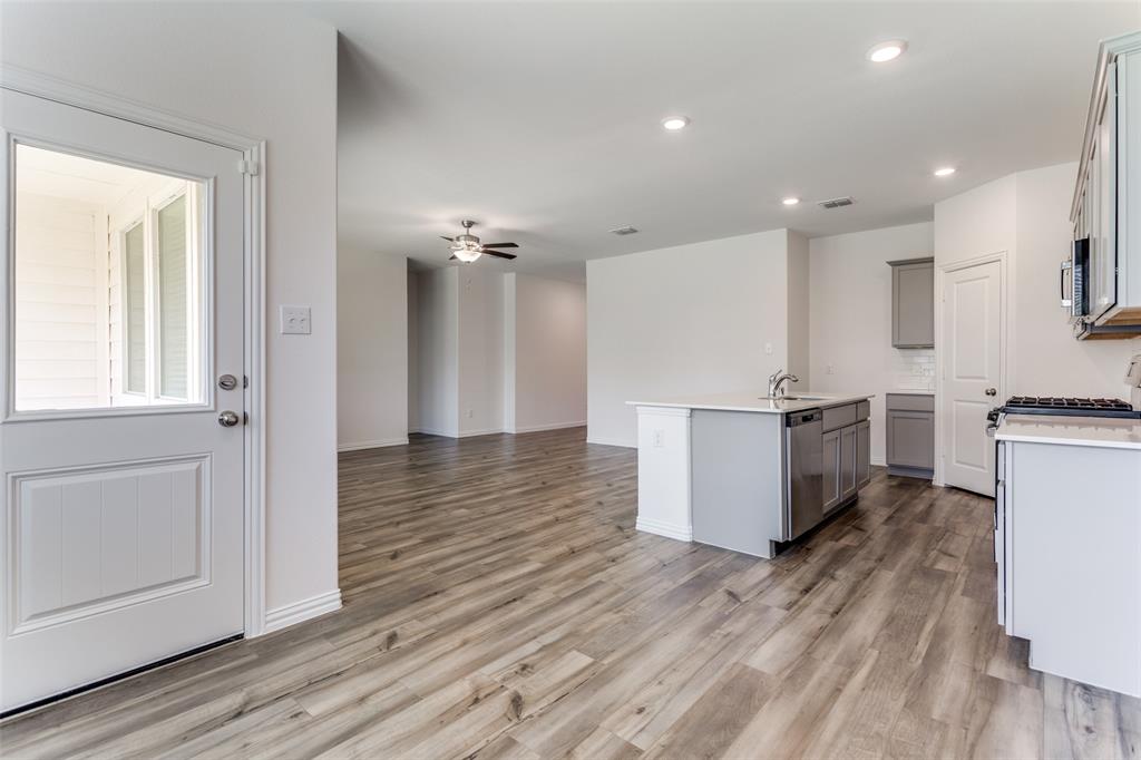 1207 Mesquite Lane Princeton, TX 75407 - Photo 9 of 25 a view of kitchen with cabinets and wooden floor