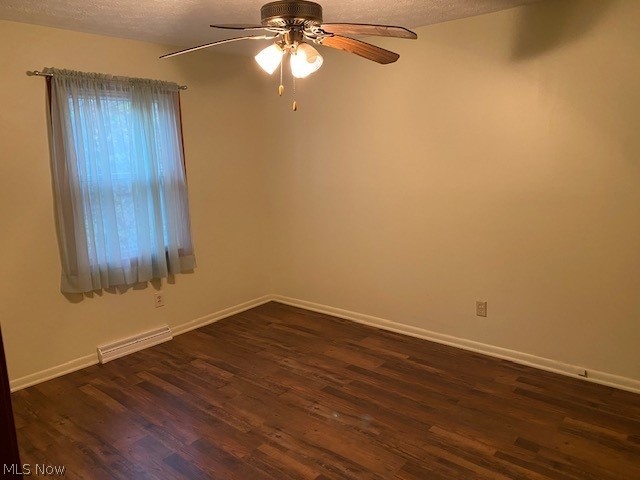 9416 Kieffer Road Mantua, OH 44255 - Photo 24 of 29 Bedroom featuring dark wood finished floors, a textured ceiling, and a ceiling fan