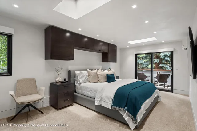 a bedroom with a bed window and couch