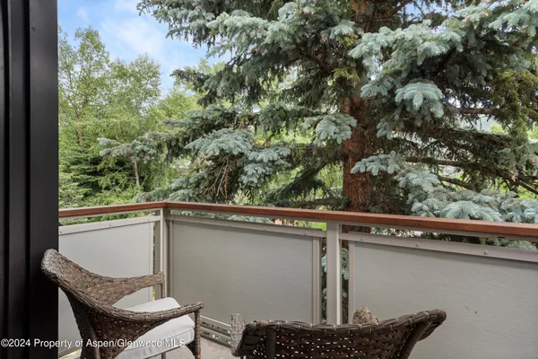 a roof deck with table and chairs