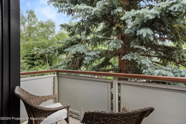 a roof deck with table and chairs