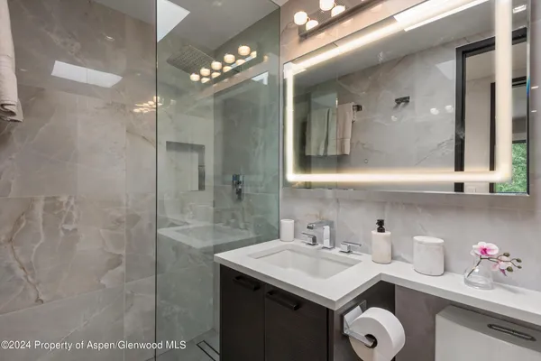 a bathroom with a sink vanity and a mirror