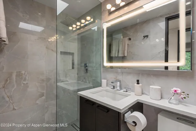 a bathroom with a sink vanity and a mirror