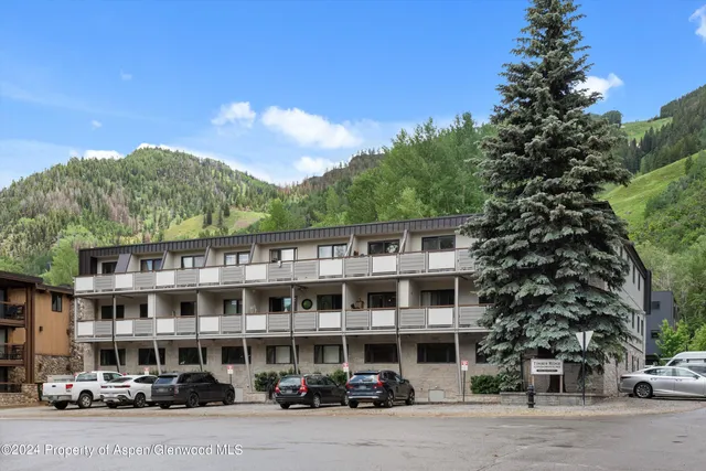 a front view of a building with trees