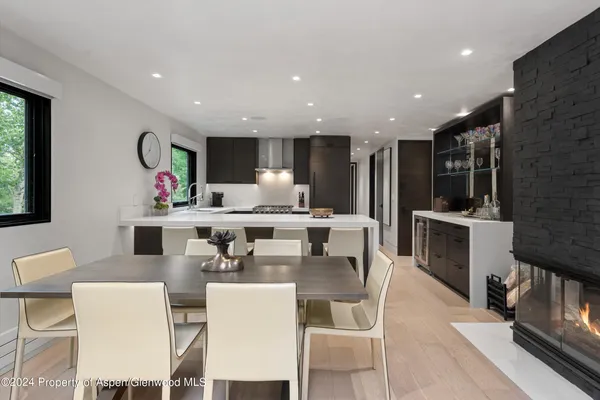 a large kitchen with a table and chairs