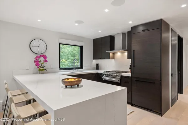 a kitchen with granite countertop a sink stainless steel appliances and cabinets