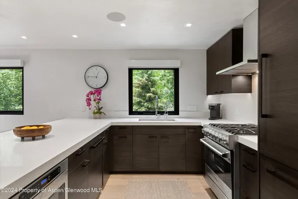 a kitchen that has a sink and a stove in it