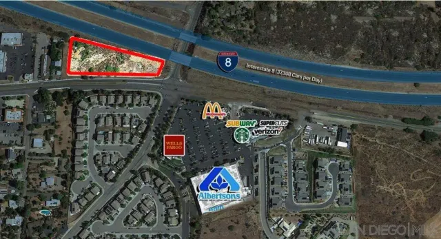 a street sign that is sitting on a brick wall