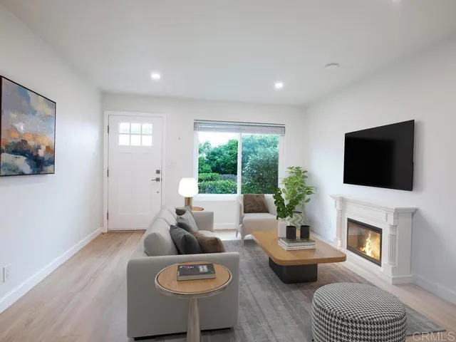 a living room with furniture a fireplace and a flat screen tv