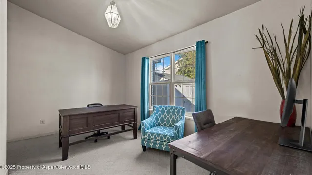 a livingroom with furniture and a potted plant