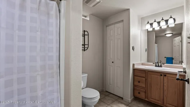 a bathroom with a sink mirror and toilet