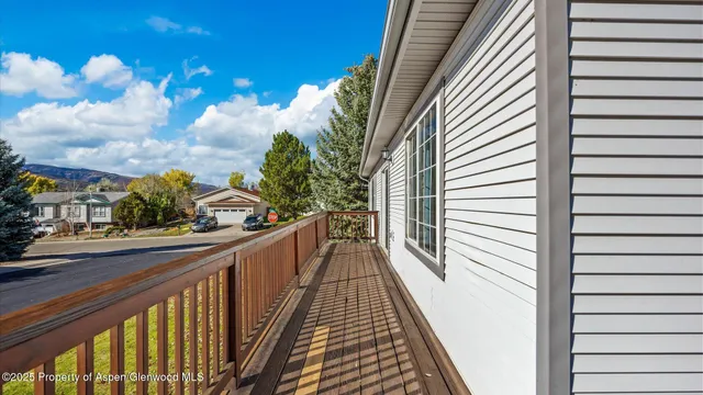a view of a balcony with wooden floor